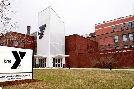 Exterior view of the Central Community Branch YMCA building with the YMCA logo and sign on the lawn.