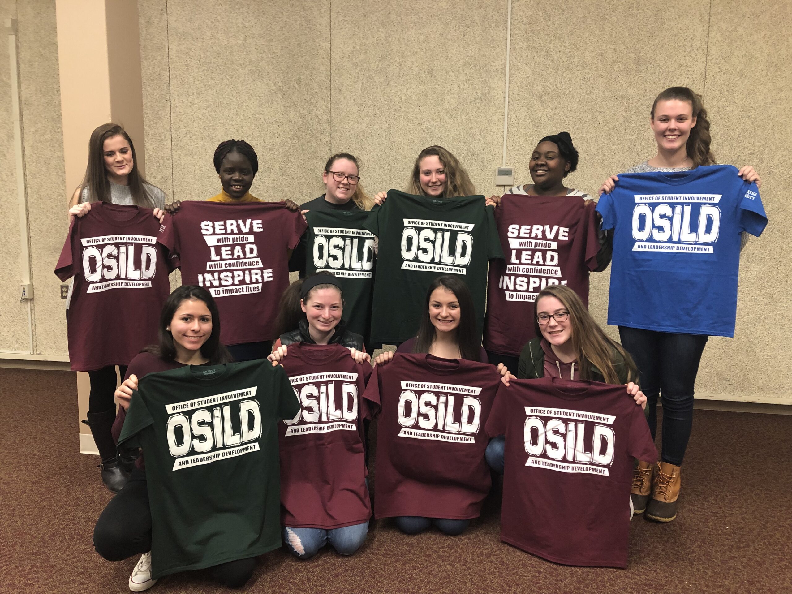 A group of young students hold OSLID group sweaters