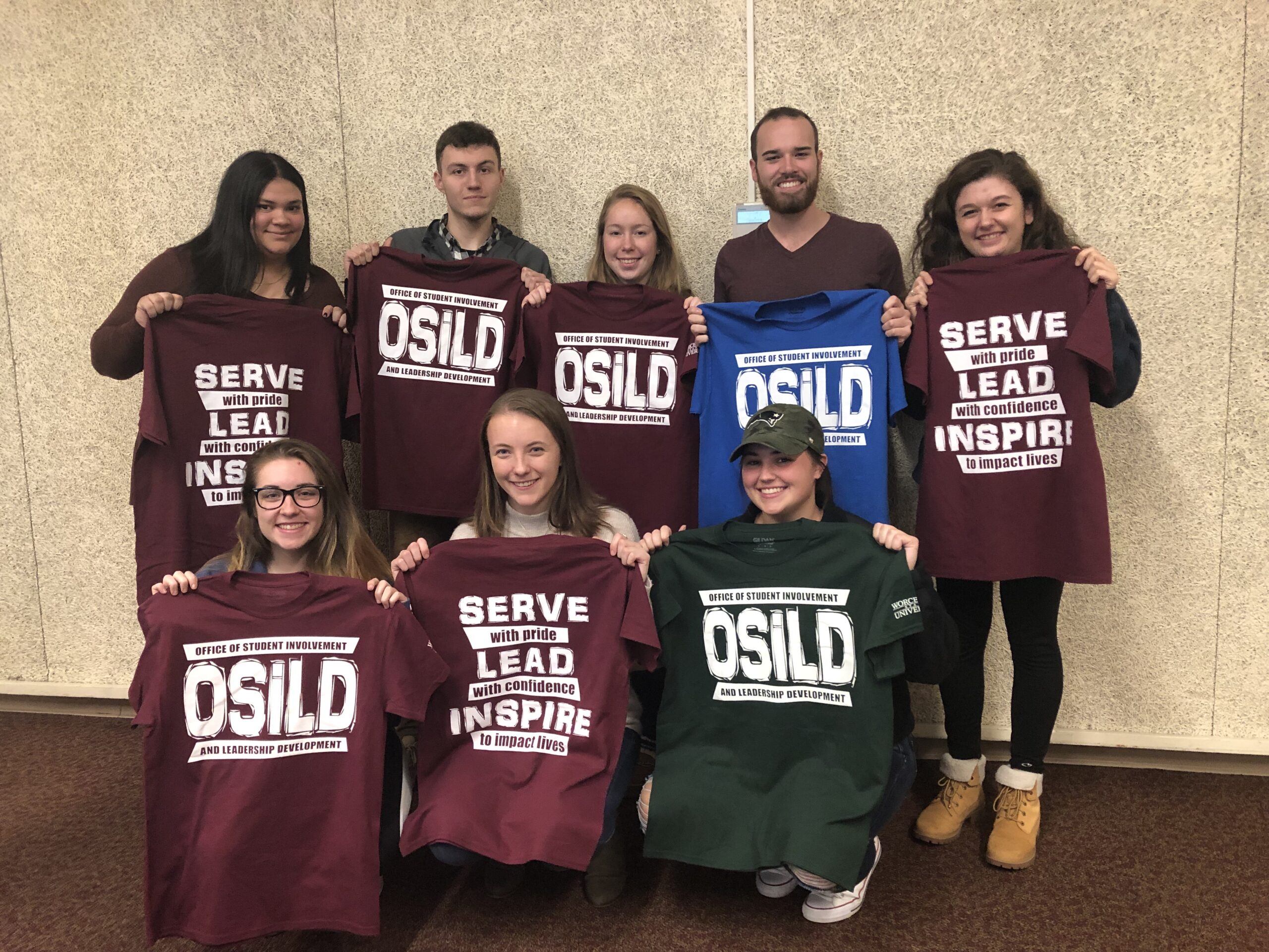 A group of students holding OSiLD sweaters