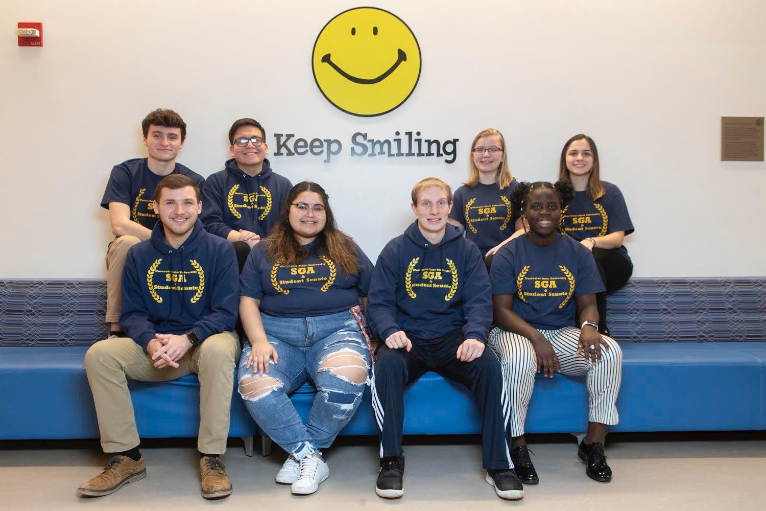 A group of students wearing SGA sweaters smiling at the camera