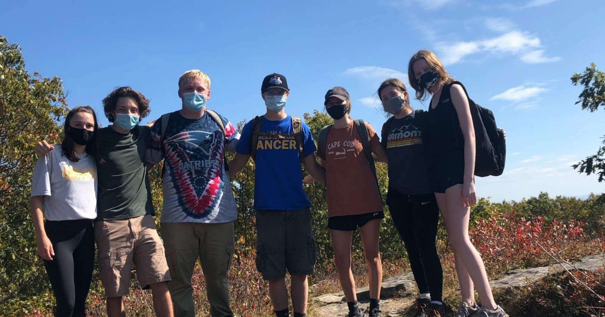 A group of students posing for a picture while on a hike