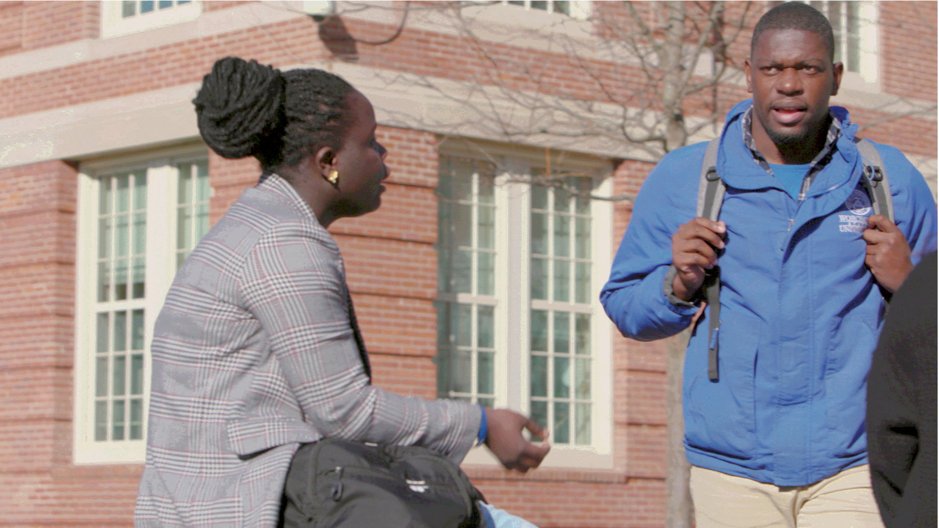 Two Worcester State students engaging in conversation outside on campus