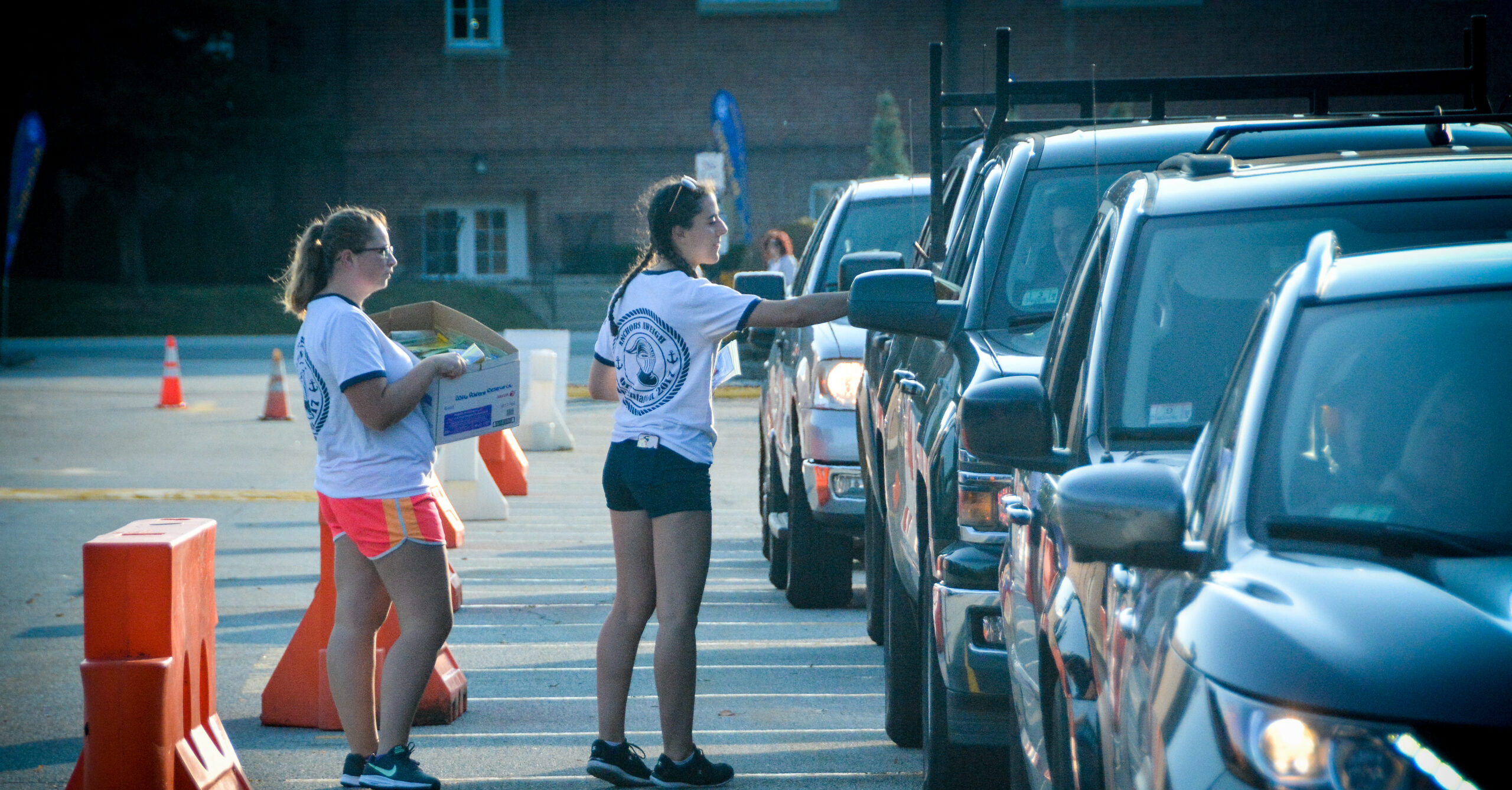 Two Worcester state students handing out information on Move-in day