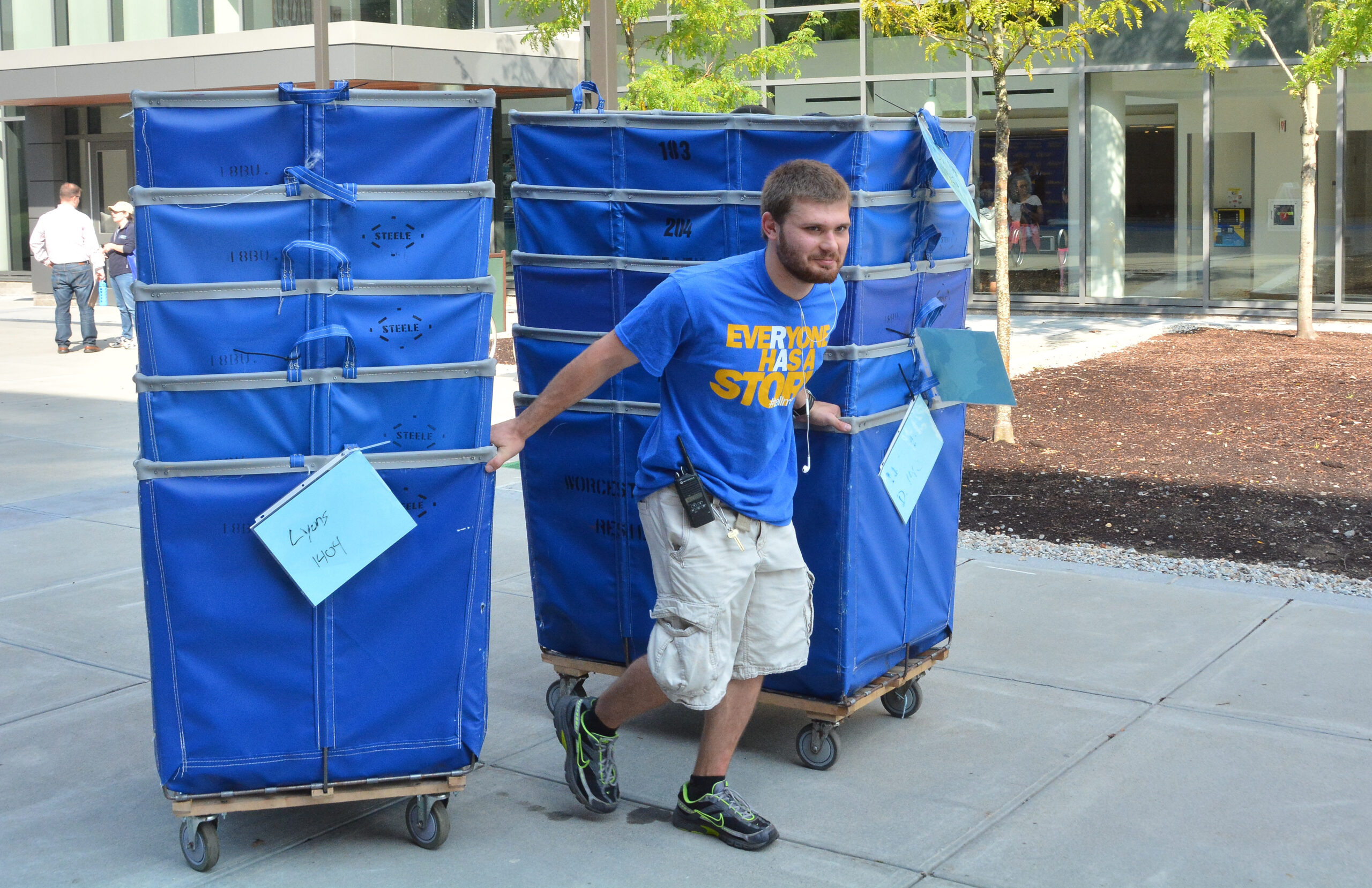 A Worcester state student pulling bins to assist in the move-in process