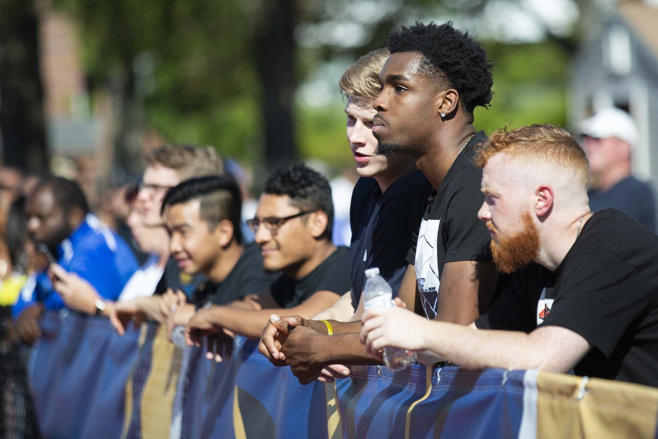 Worcester State university football fans watching the game on the sidelines