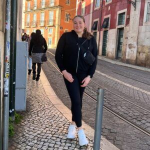 Student stands on cobble street