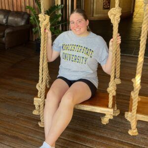 Student sits on swing in WSU shirt
