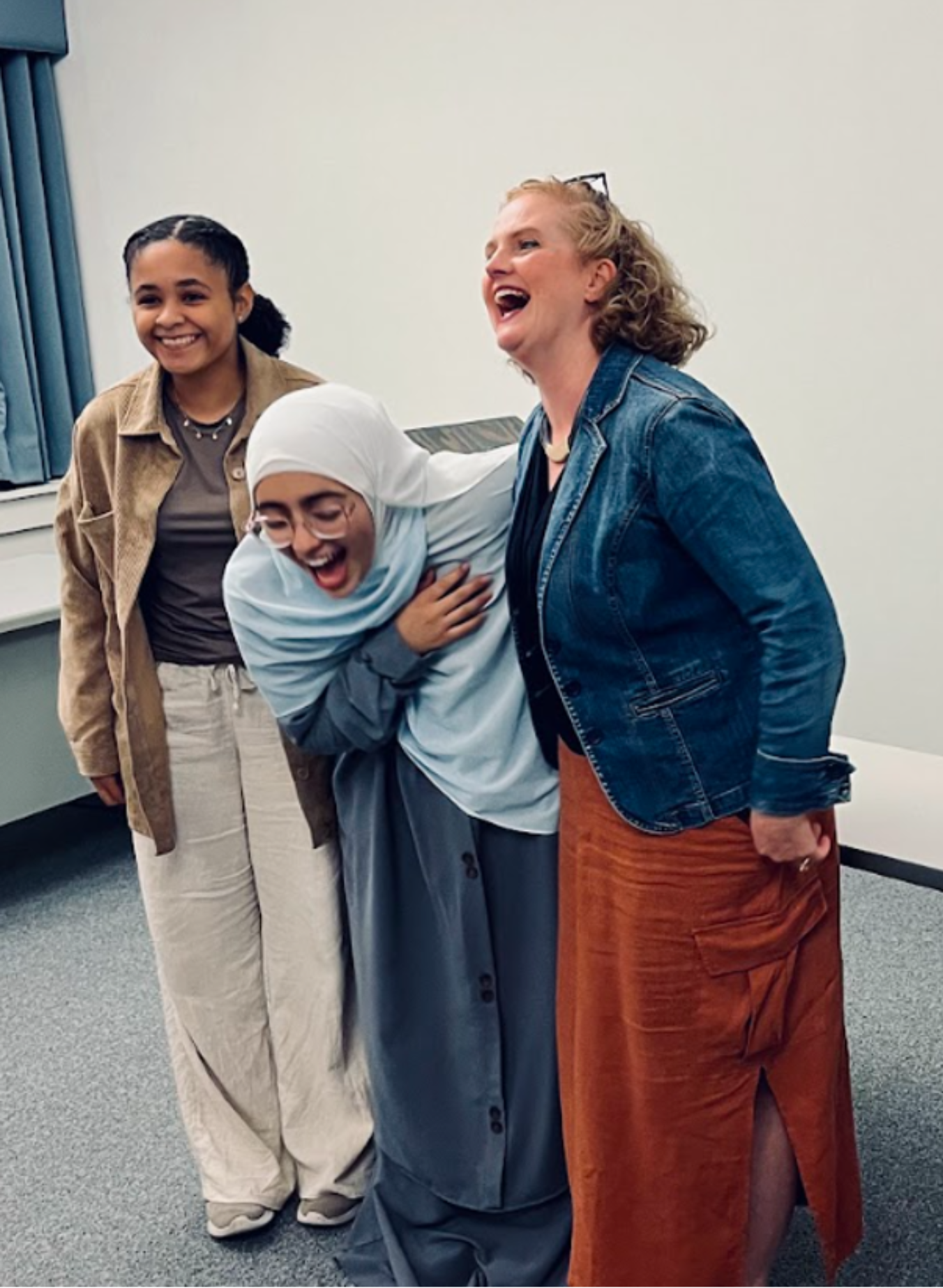 three woman (Tiernan O’Neal [left], Tona Hangen [middle], Maroua Rahaoui [right]) standing laughing