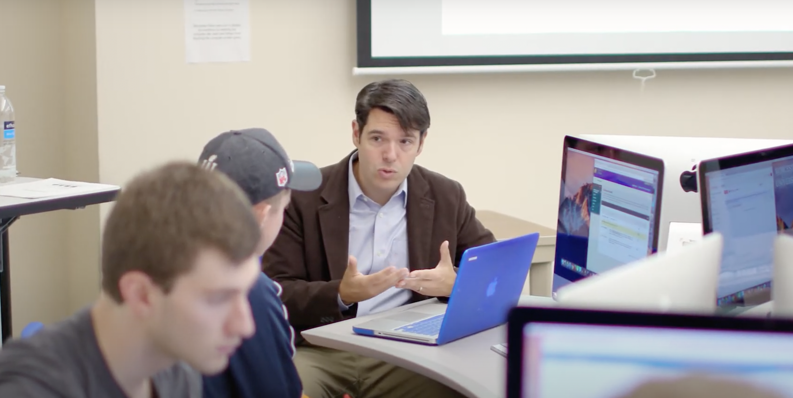 Communication professor at Worcester State working with students in the editing suite