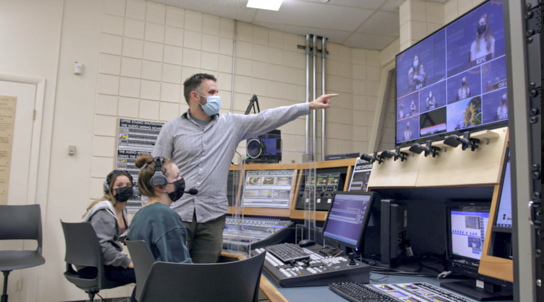 Communication professor assisting a student in the switch room