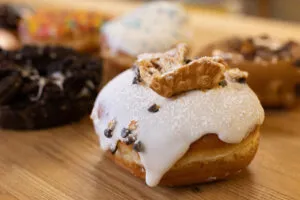 Close-up of a doughnut with frosting and pieces of a cannoli shell