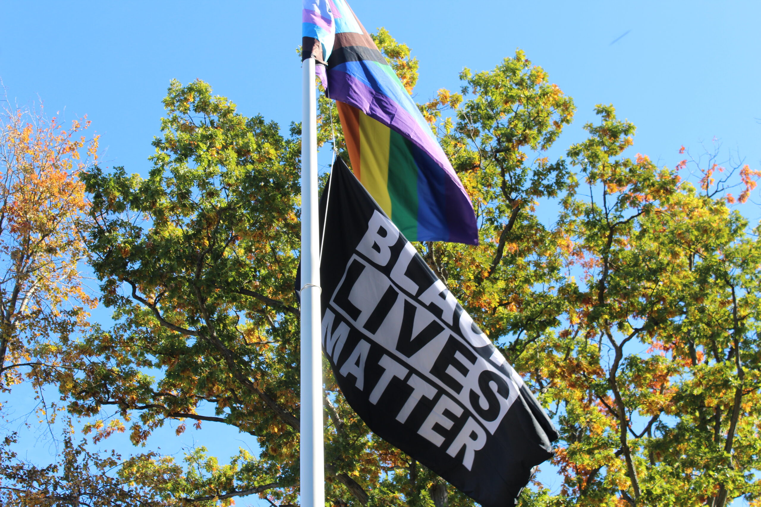 Pride flag and Black Lives Matter flag on a flagpole