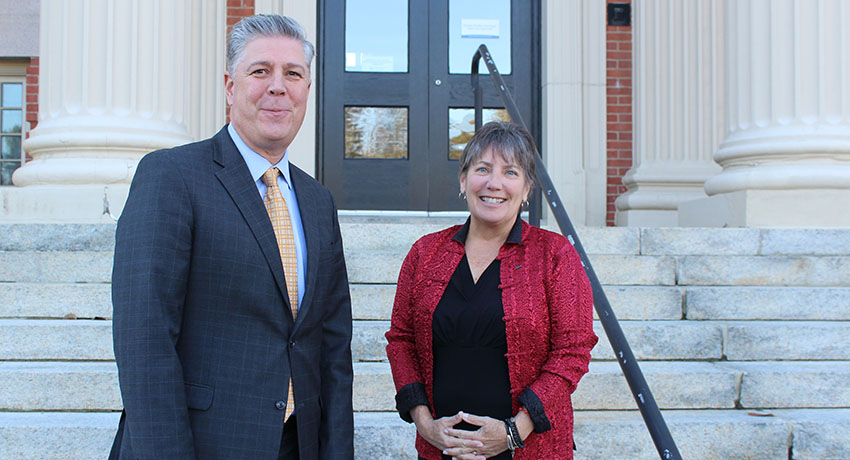 President Barry Maloney and Senator Anne Gobi stand outside, in front of the steps to a building on the Worcester State campus
