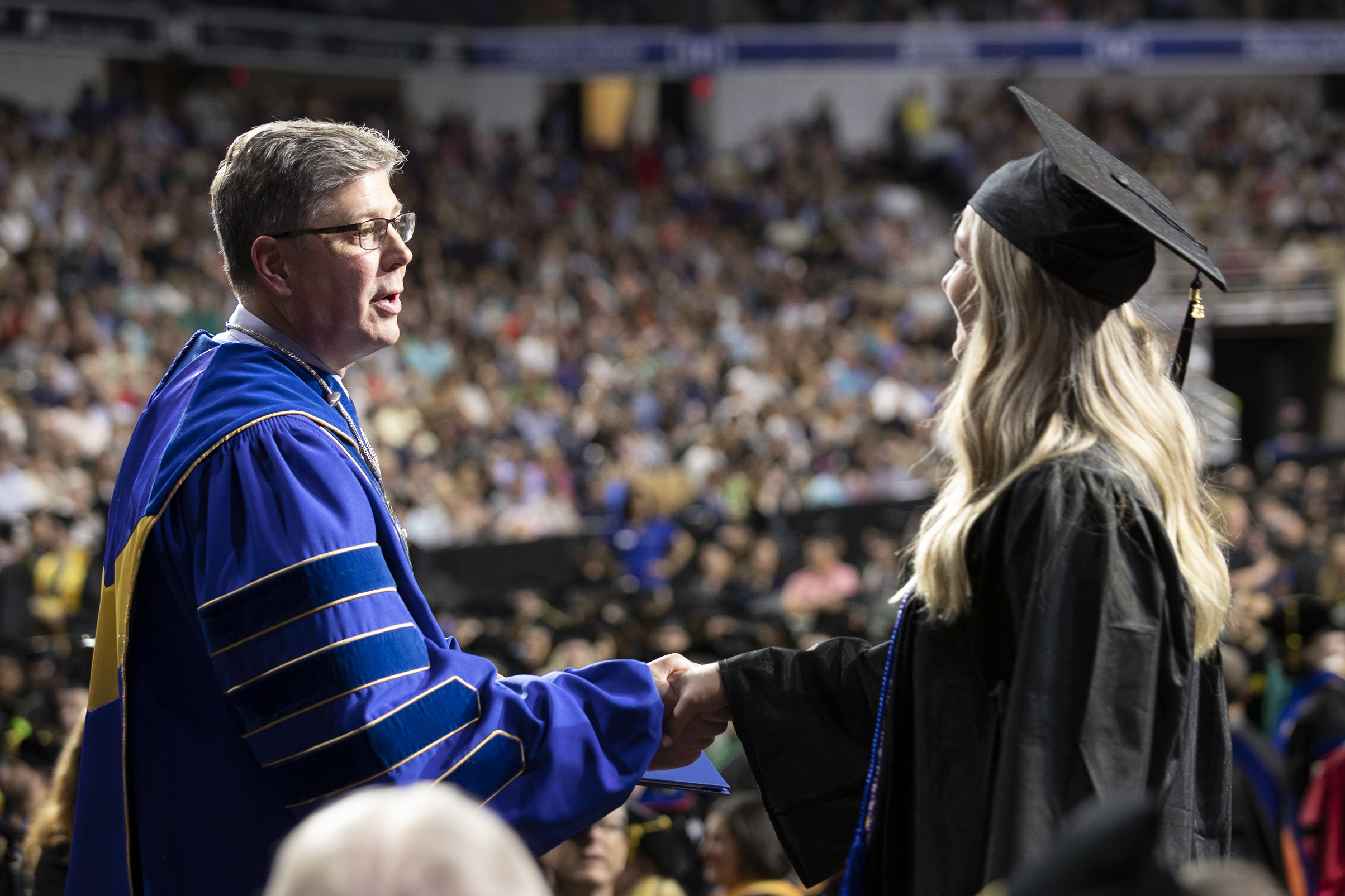 Worcester State commencement, student shakes President Maloney's hand