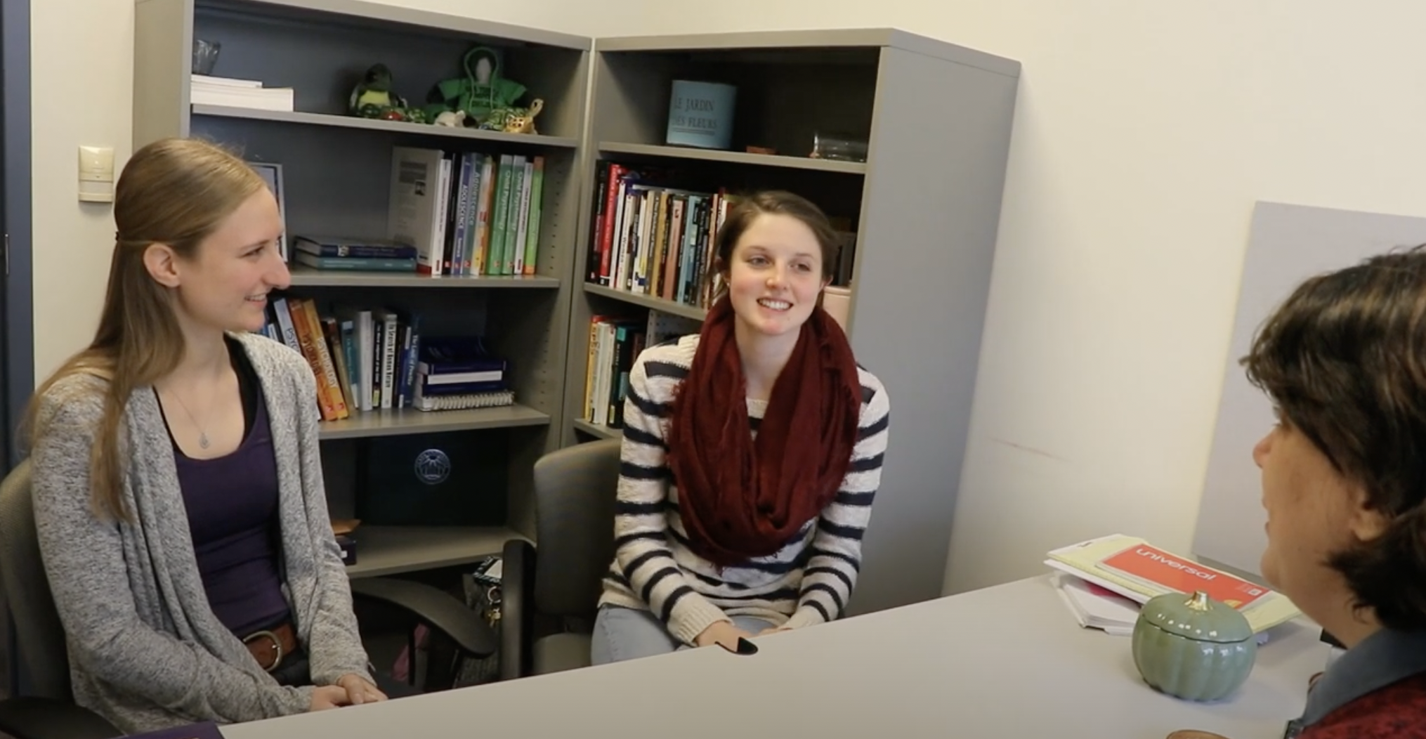 Two psychology students at Worcester State speaking with professor