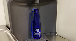 A water bottle filling in a hydration station
