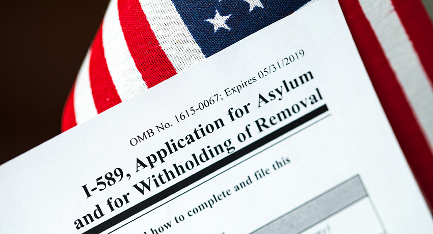 Application for asylum to USA concept with application form and USA flag