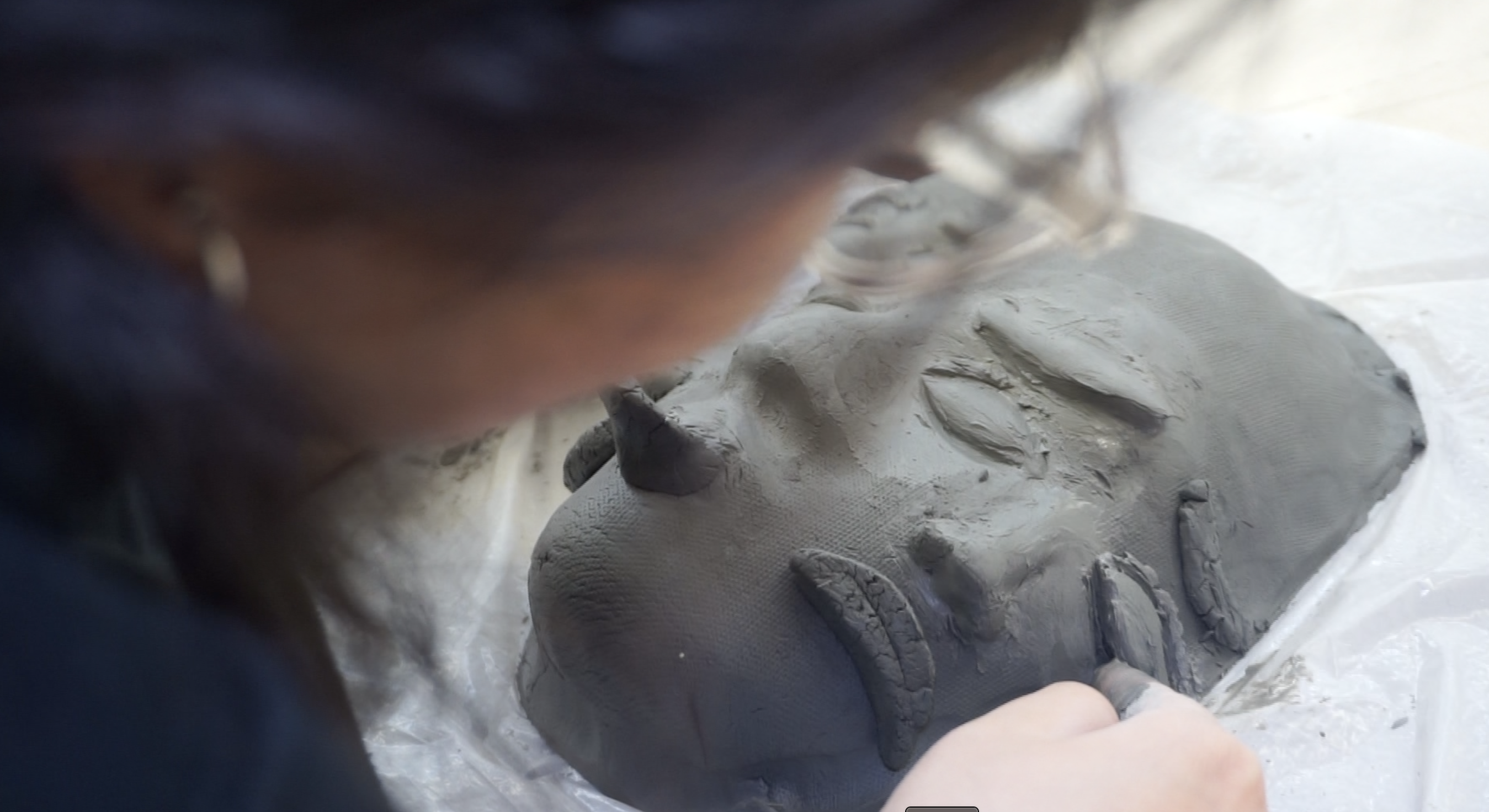 Art student pottery mask with 3 faces