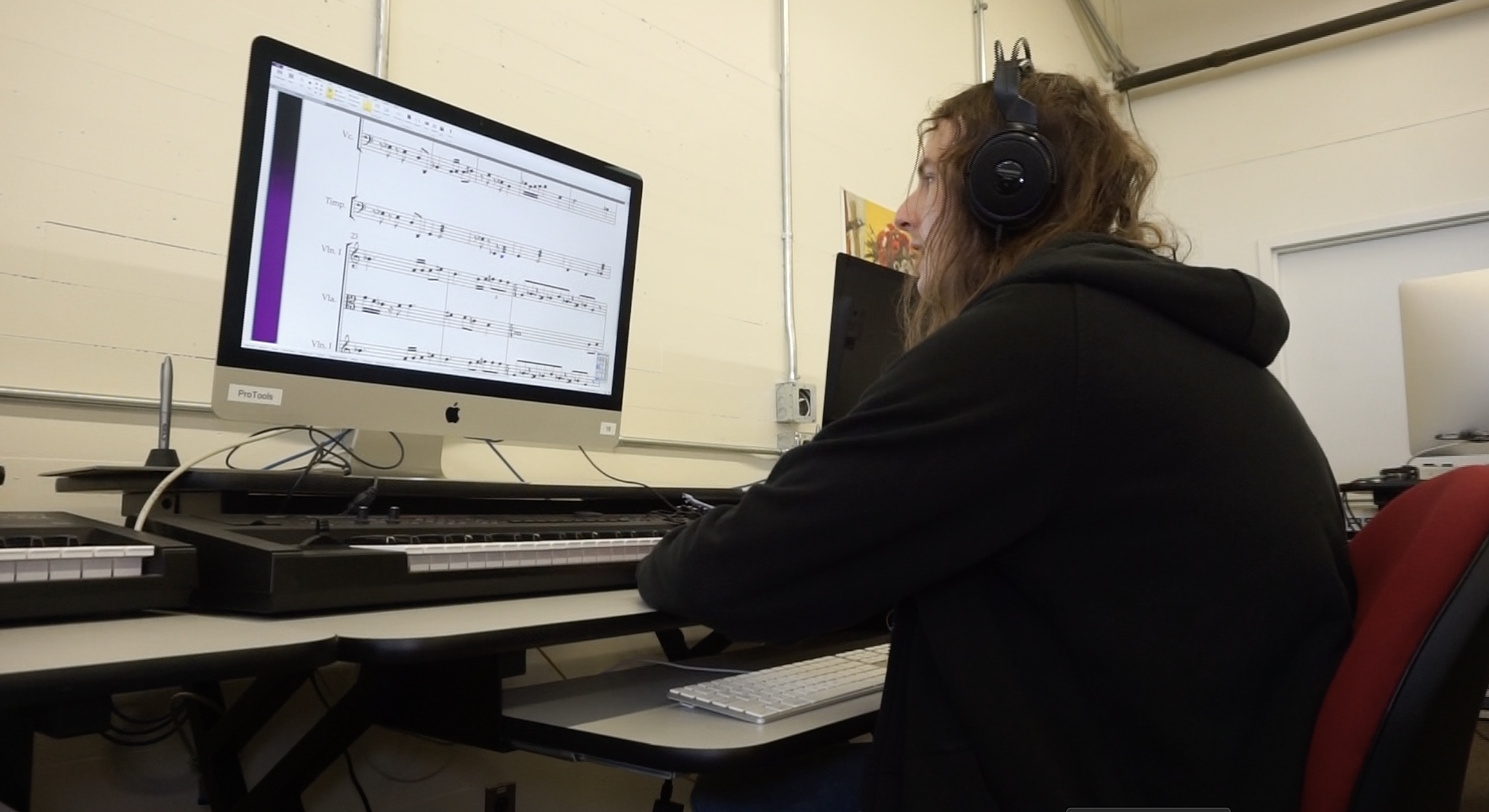 Music composition major working on computer at Worcester State