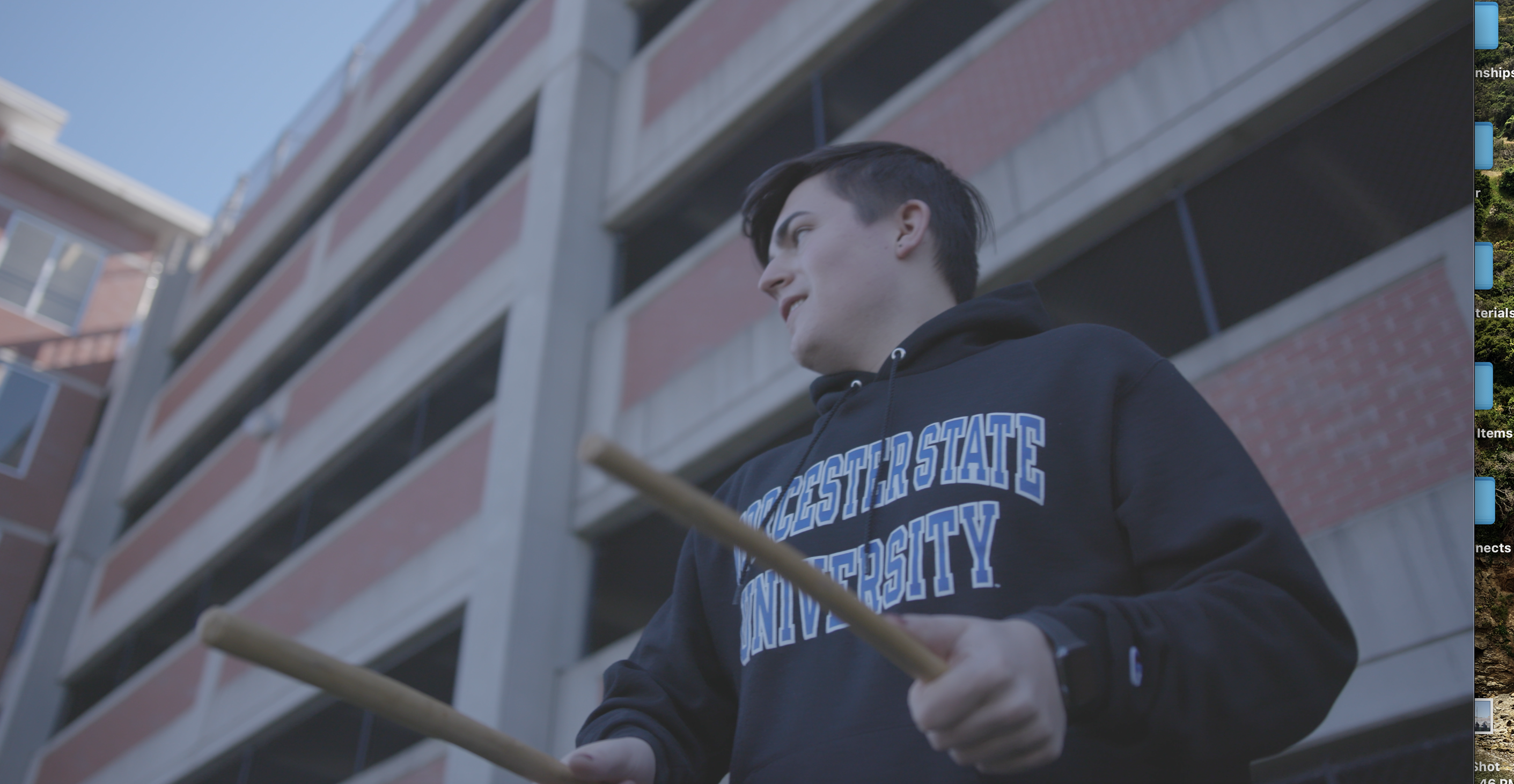 Worcester State music student African Drumming in front of the parking garage