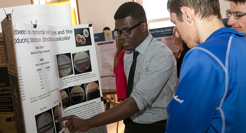 A Worcester State student presenting research in front of other students