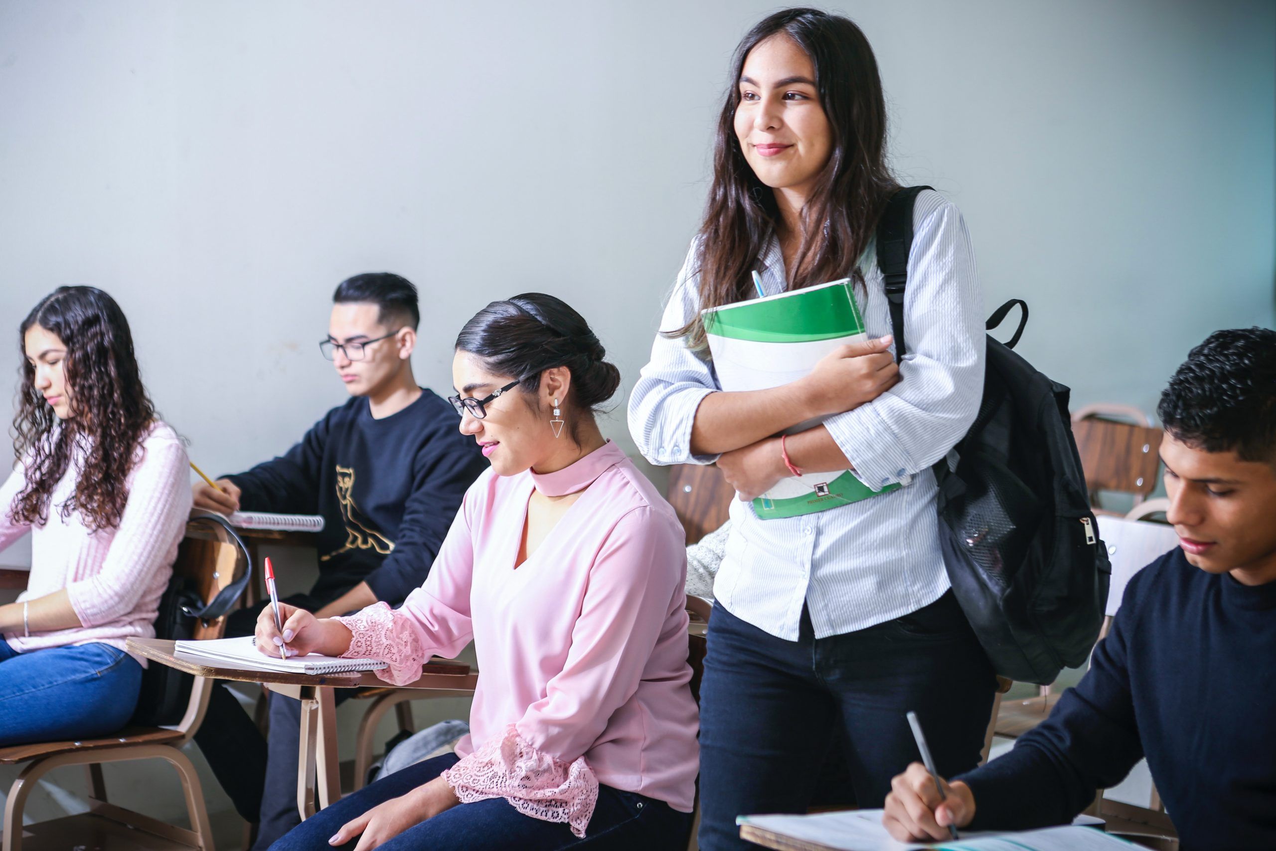 A smiling student walking into class