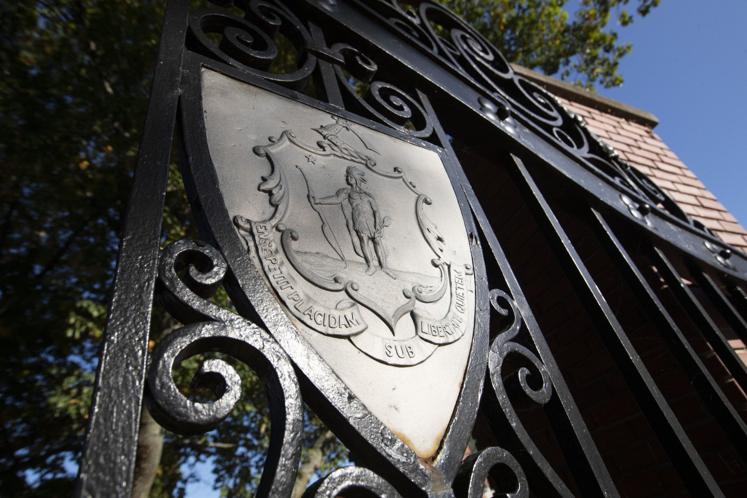 The Worcester State university seal on the university's iron gates