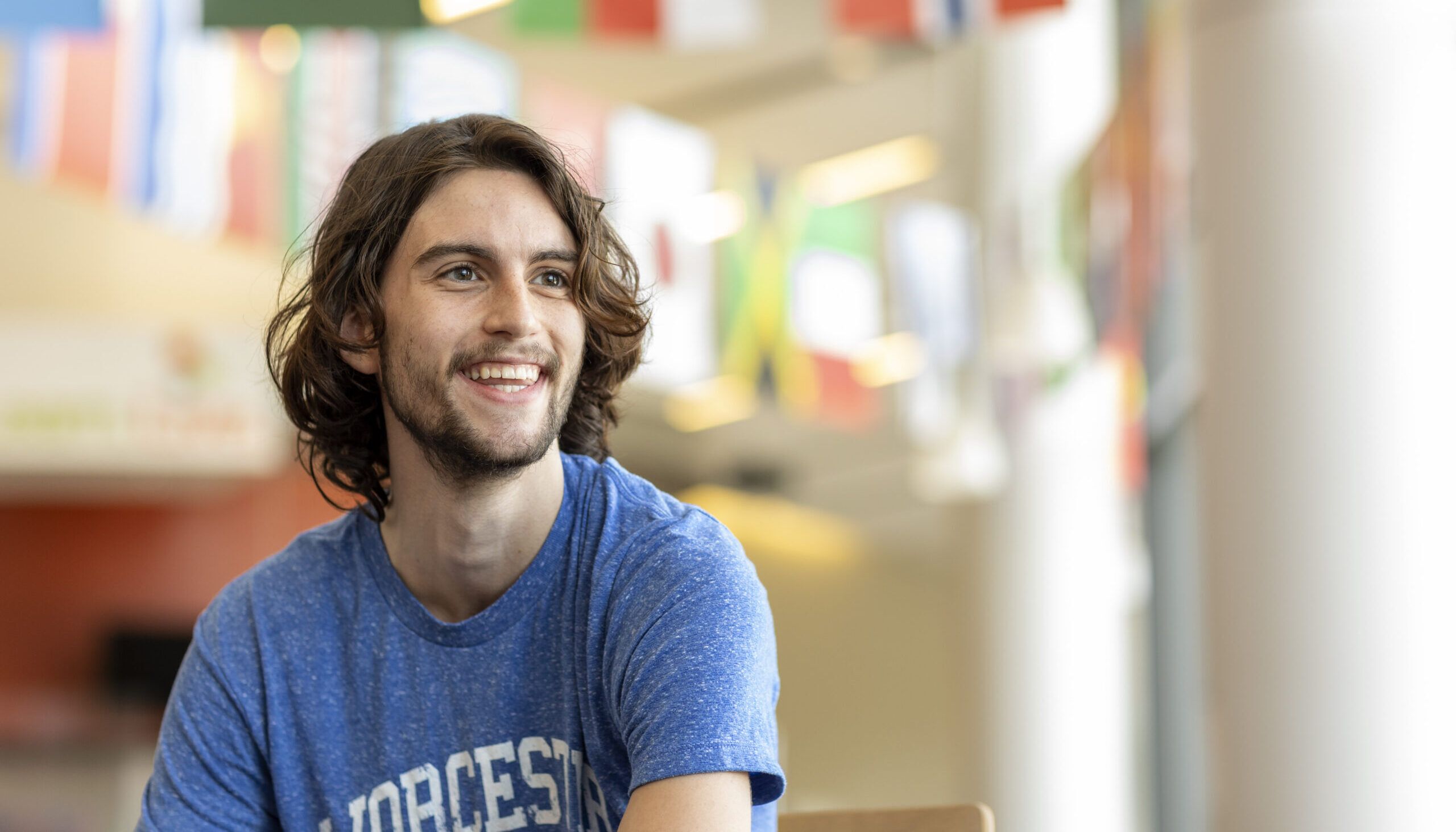 A smiling Worcester state student at the dining hall