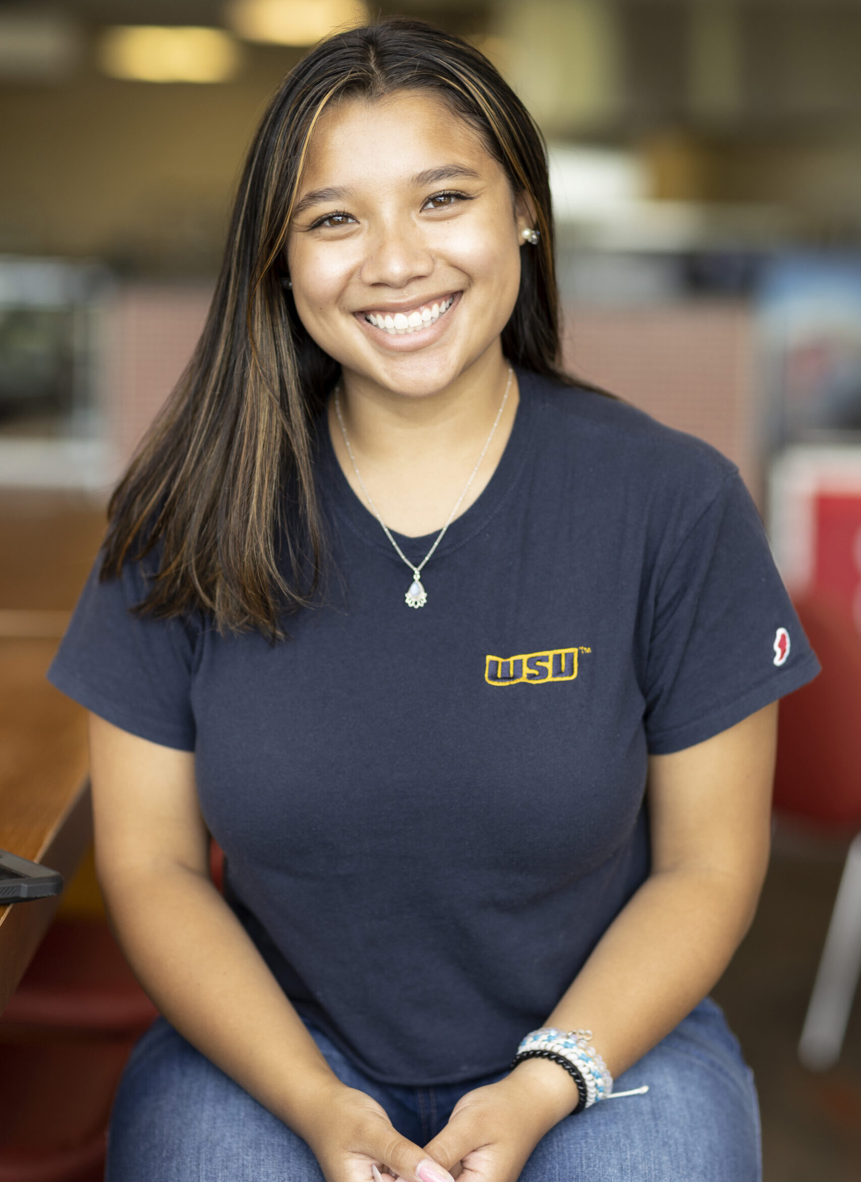 A smiling Worcester State student wearing a WSU teeshirt