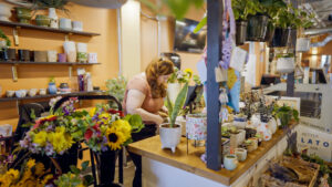 A plant shop in downtown Worcester with an employee behind the counter