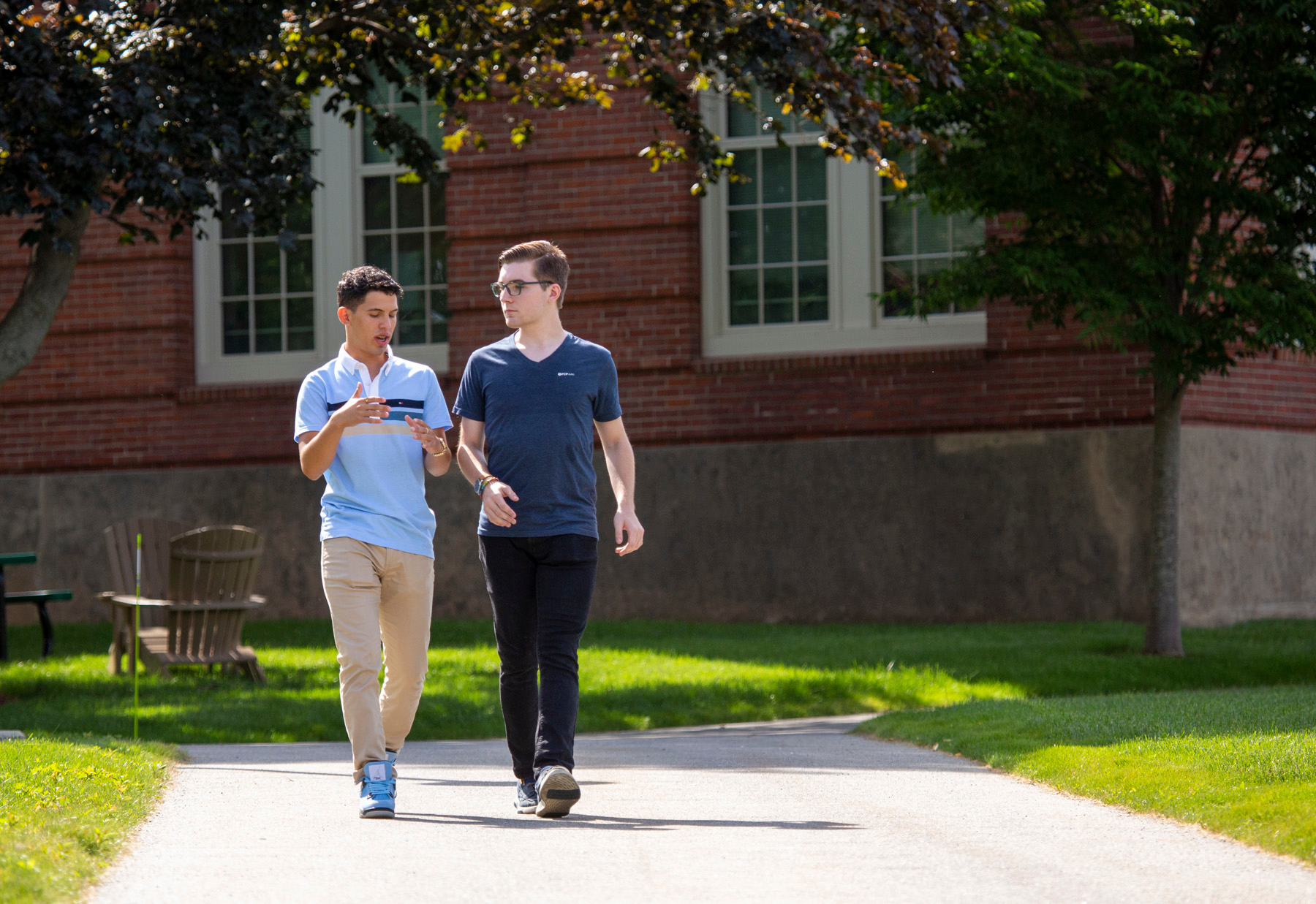 Two Worcester State Students talking together as they walk on campus
