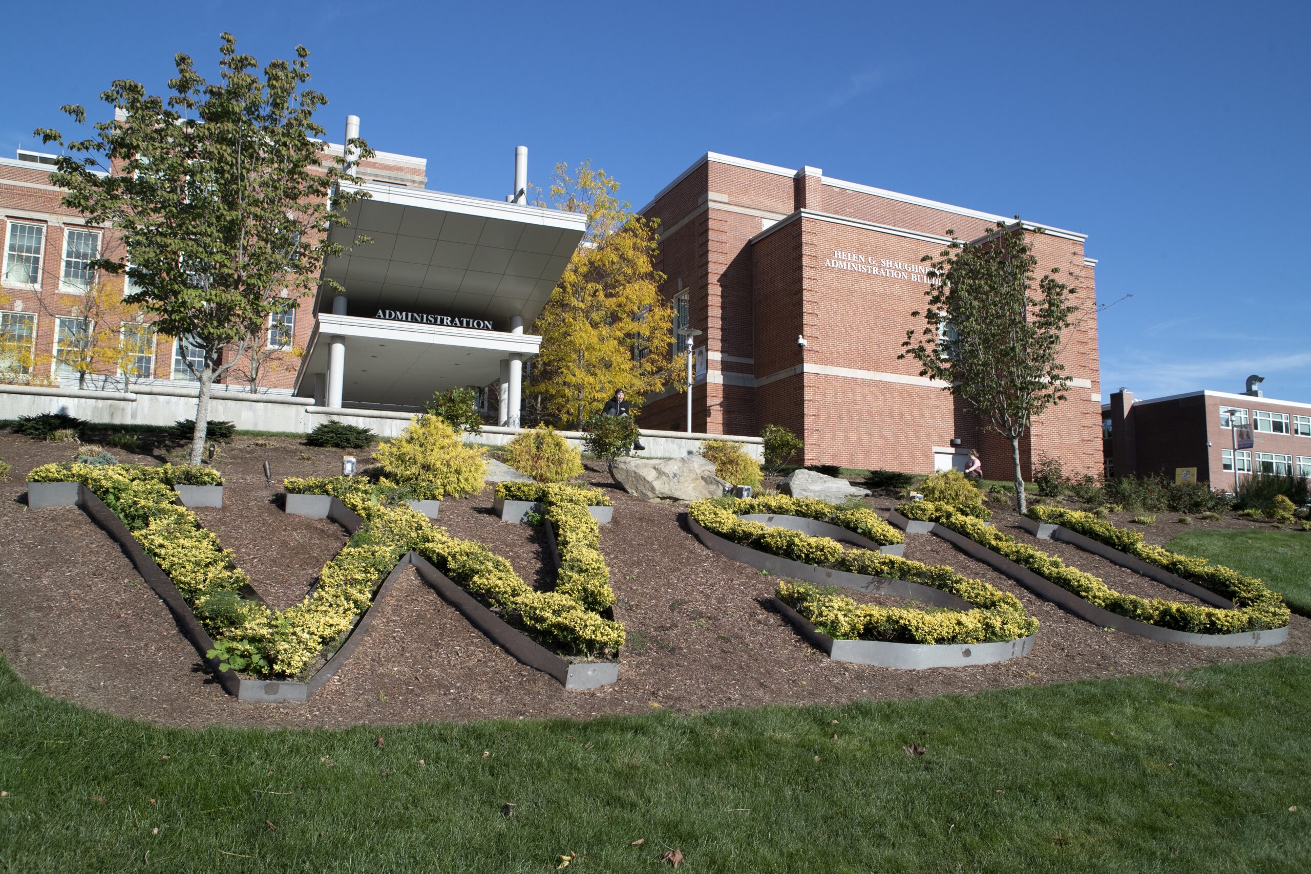 Worcester State University's 'WSU' acronym spelled out on the lawn in yellow flowers