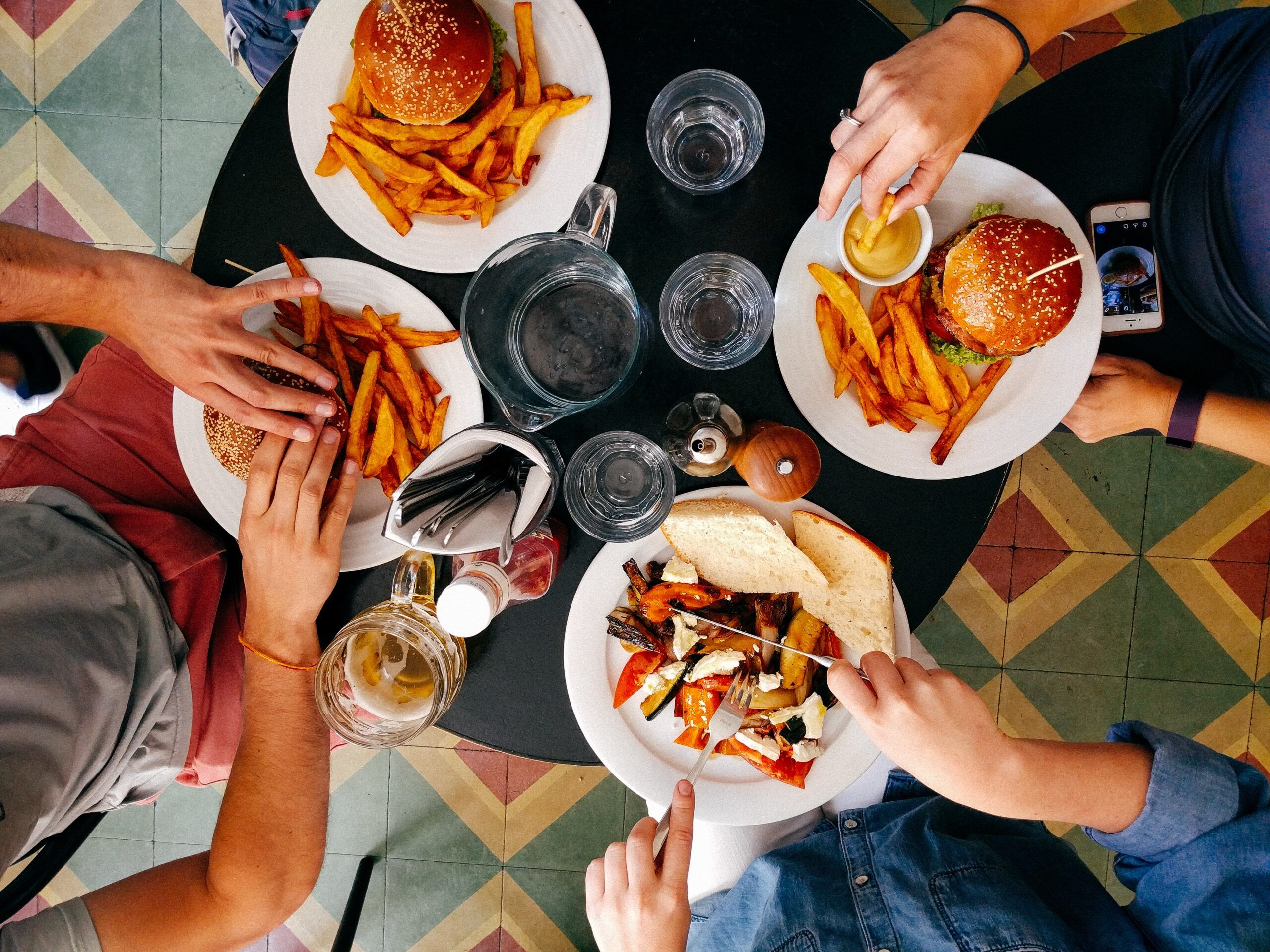 A group of students eating burgers together