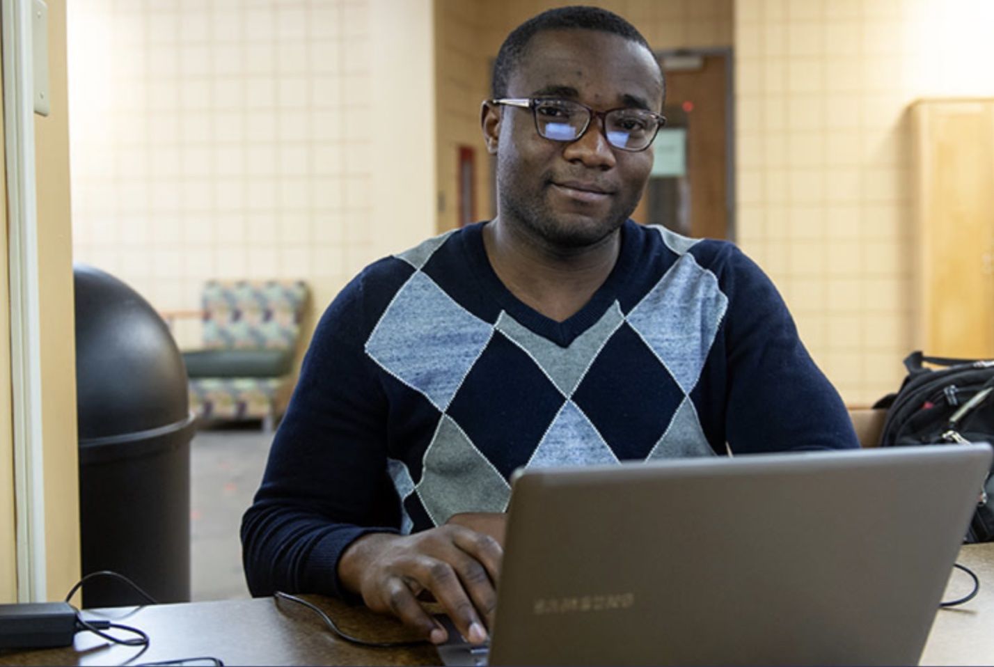 A Worcester State student working on a laptop at the campus