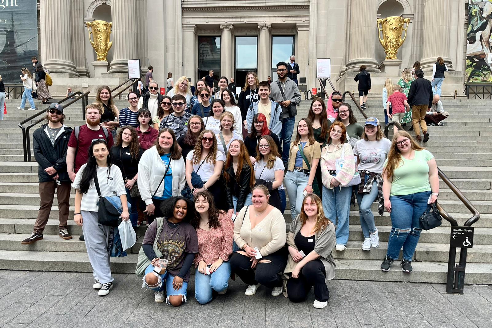 Students sitting on steps of MET in NYC