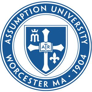 Assumption University seal featuring a shield with a cross, crown, book, and fleur-de-lis, encircled by the text "Assumption University Worcester MA 1904.
