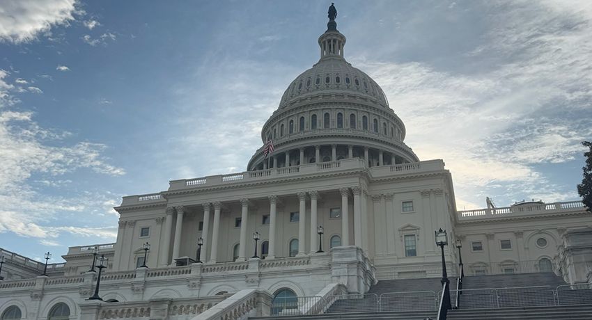 The United States Capitol building under a partly cloudy sky, viewed from the steps looking upward toward the dome, evokes a sense of inspiration much like Worcester State University’s iconic campus landmarks.